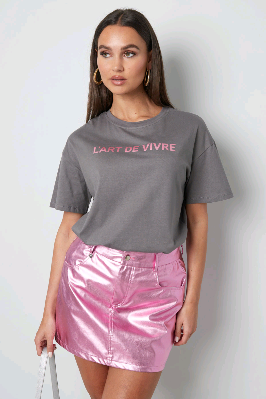 Roze metallic rokje dames en grijs t-shirt met metallic roze letters, is je ideale festival outfit.